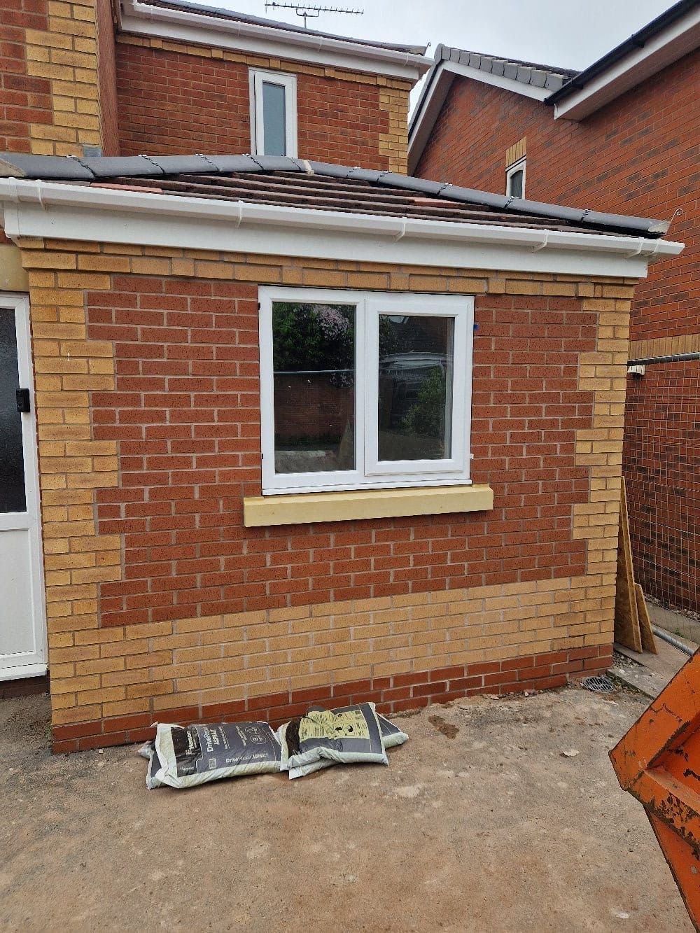 Extension brickwork under construction around a new window opening | home extensions in King's Lynn by Humphries Construction