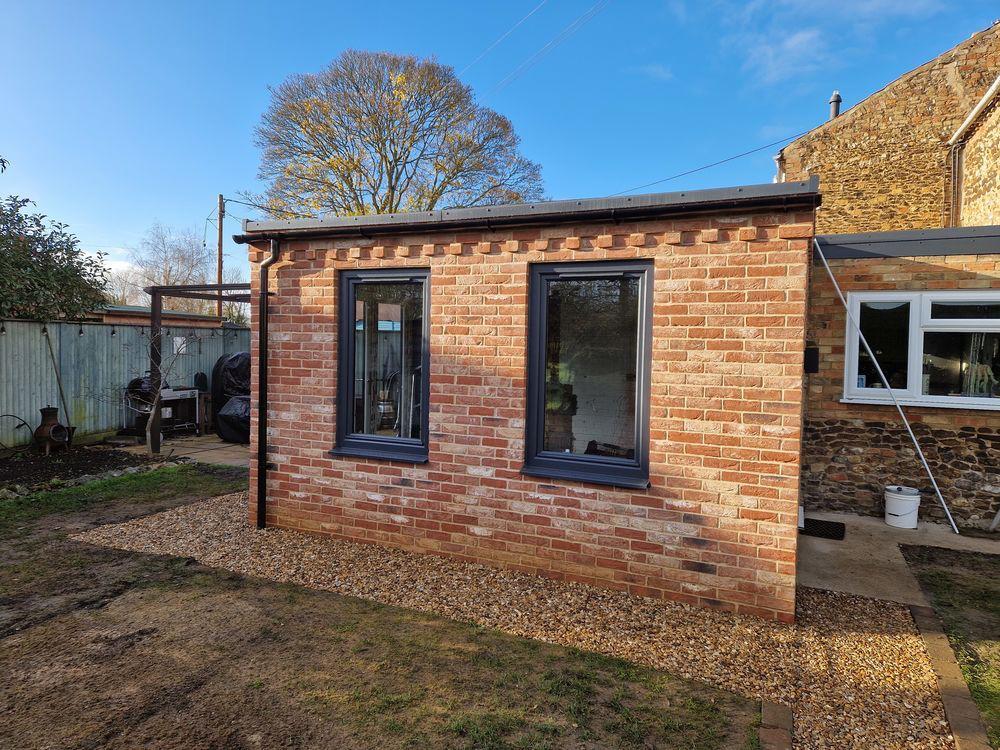 Completed brick garden room extension with bifold doors | home extensions in King's Lynn by Humphries Construction