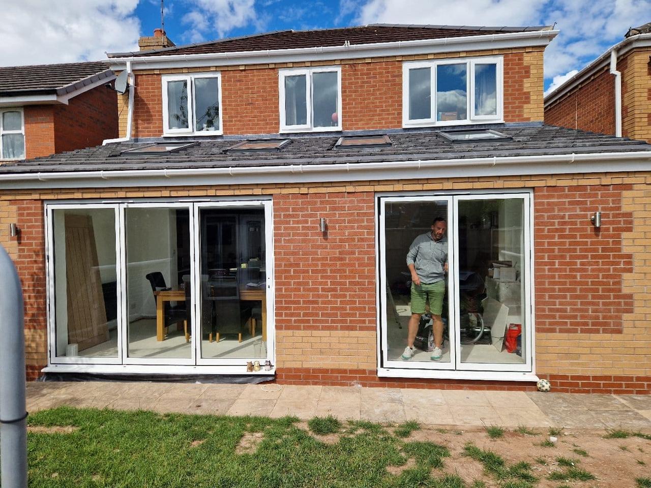 Finished rear extension with full-width bifold doors opening to garden | home extensions in King's Lynn by Humphries Construction