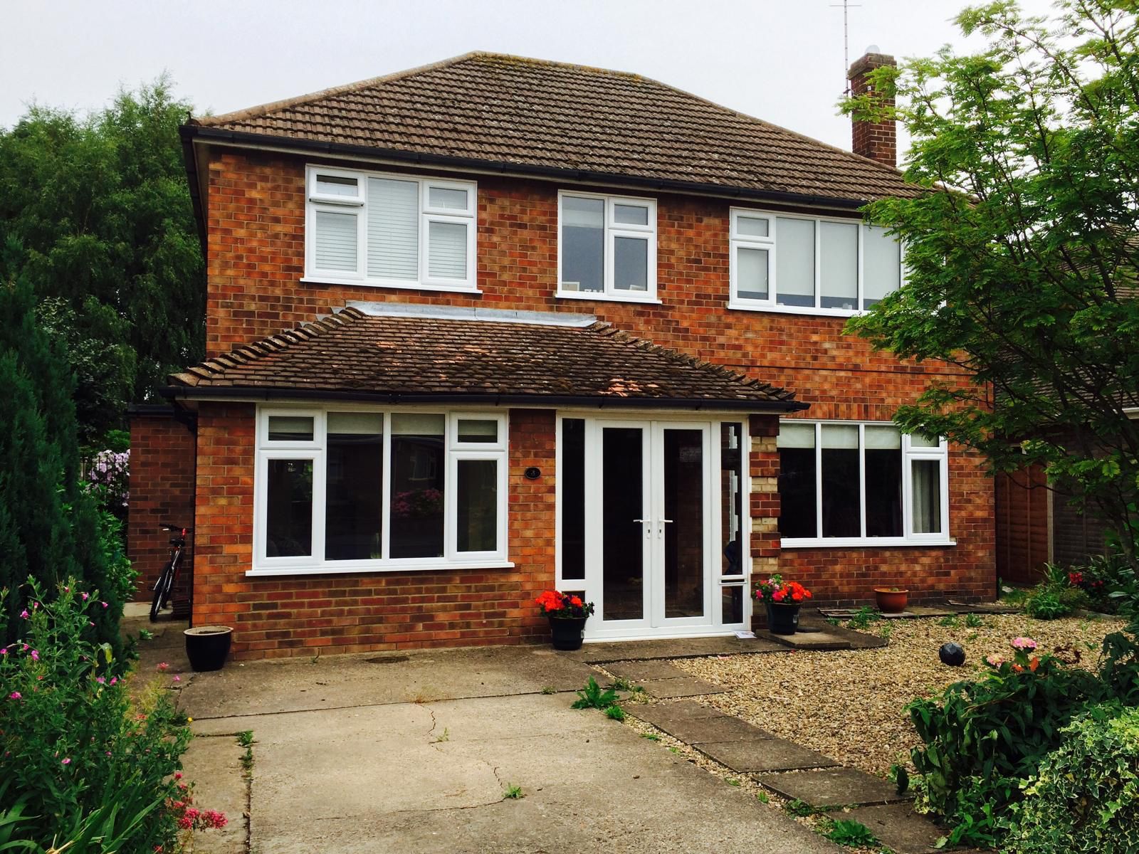Landscaped rear extension with rendered walls and patio | home extensions in King's Lynn by Humphries Construction